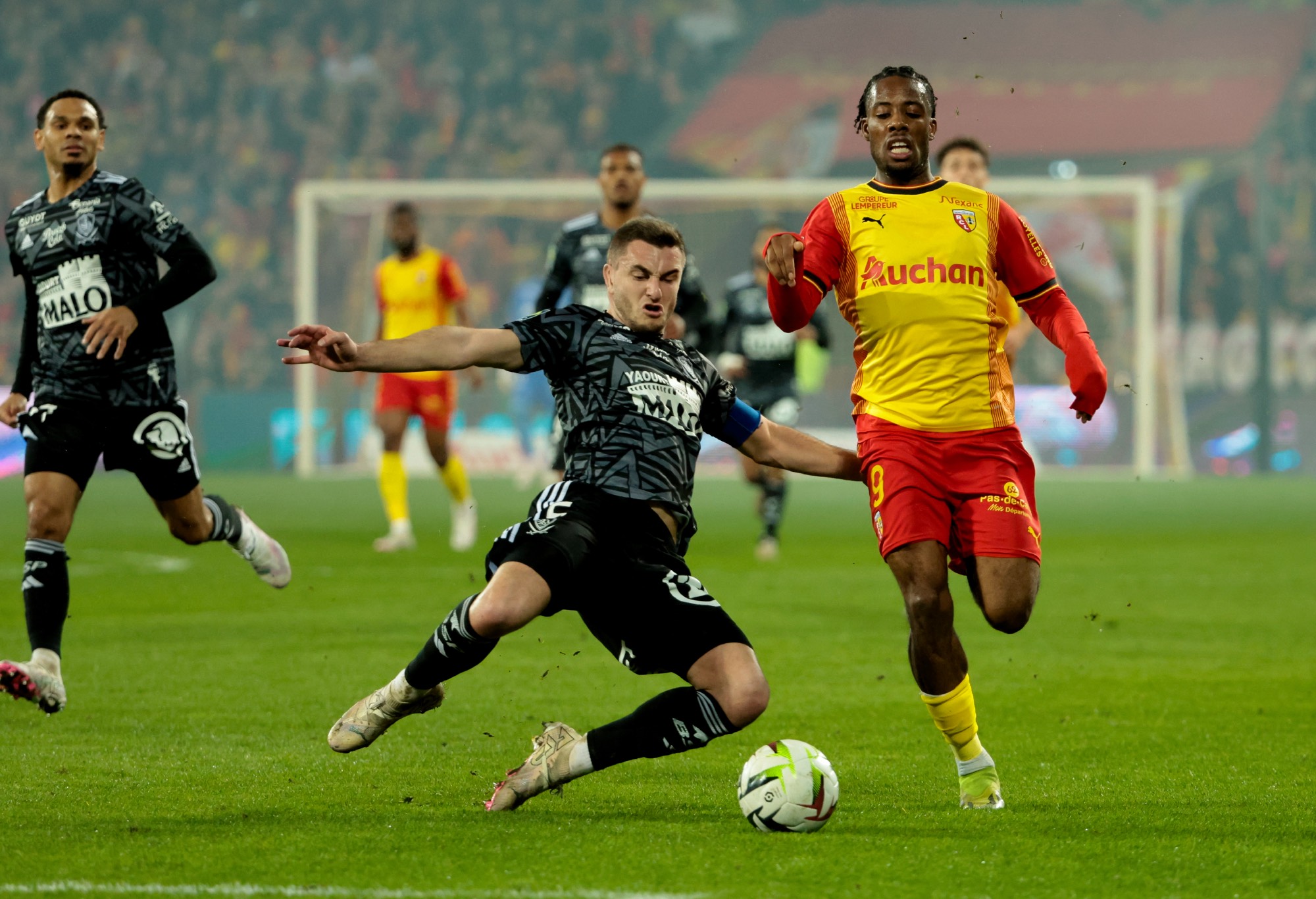 Elye Wahi of Lens, left Brendan Chardonnet of Brest in action during the Ligue 1 Uber Eats match between RC Lens and Stade Brestois 29 at Stade Bollaert-Delelis on March 9, 2024 in Lens, France. (Photo by Jean Catuffe/Getty Images)