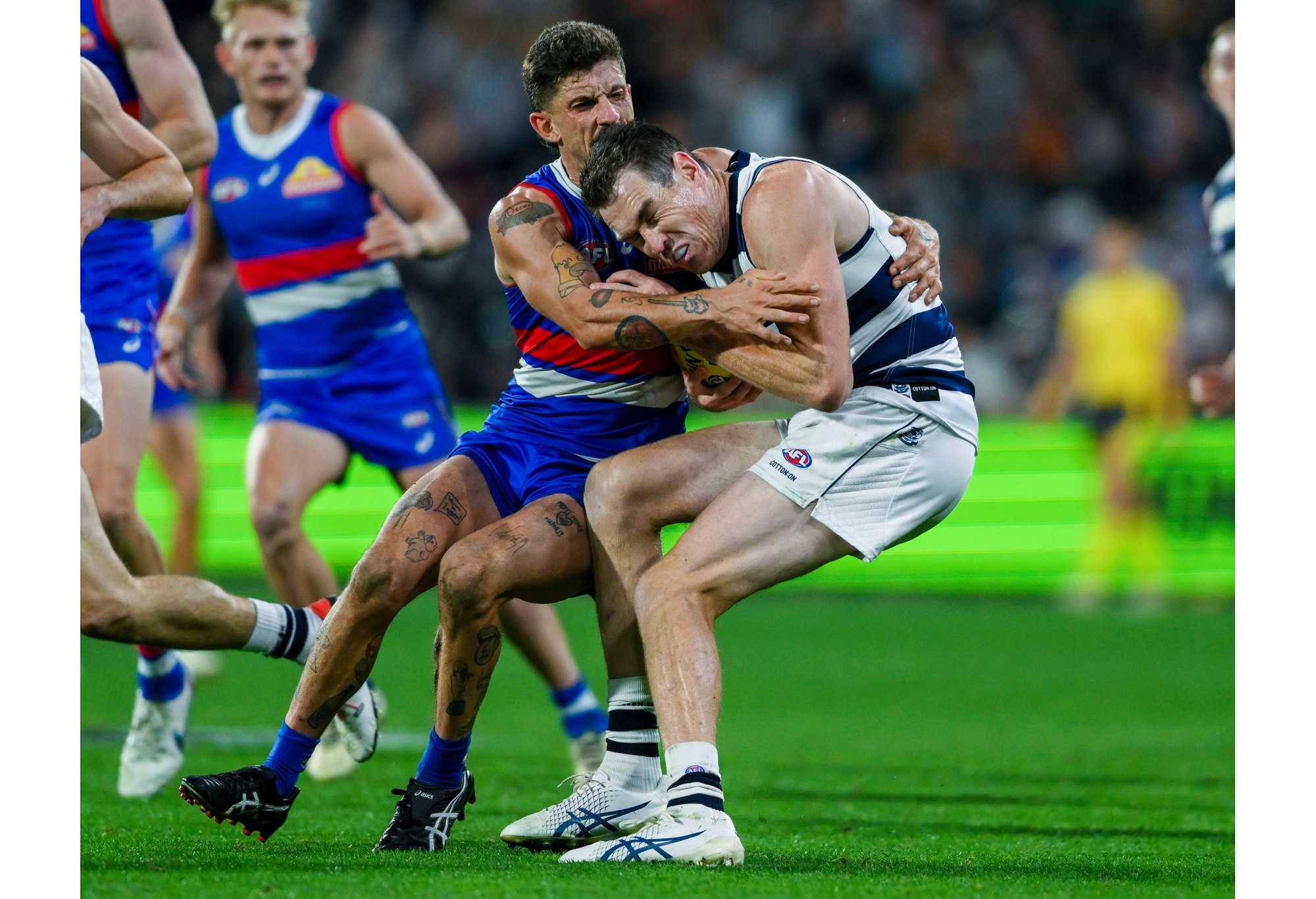 Jeremy Cameron of the Cats tackled by Tom Liberatore of the Bulldogs during the round four AFL match between Western Bulldogs and Geelong Cats at Adelaide Oval, on April 06, 2024, in Adelaide, Australia. (Photo by Mark Brake/Getty Images)