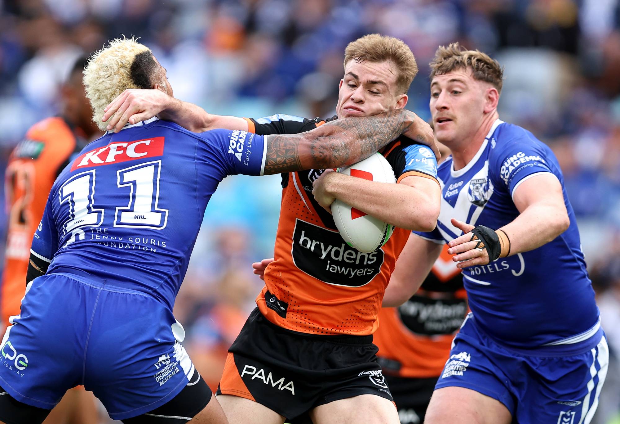 SYDNEY, AUSTRALIA - MAY 04: Lachlan Galvin of the Tigers is tackled by Viliame Kikau of the Bulldogs during the round nine NRL match between Canterbury Bulldogs and Wests Tigers at Accor Stadium, on May 04, 2024, in Sydney, Australia.
